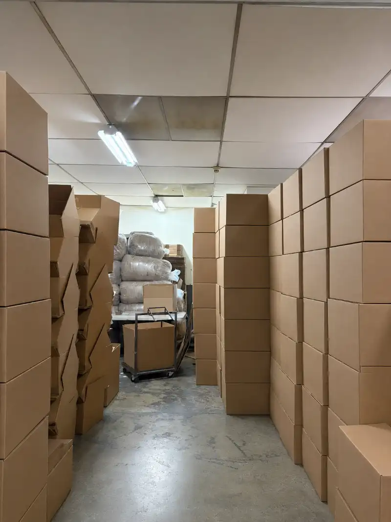 Bodega en uso con cajas y un pasillo central